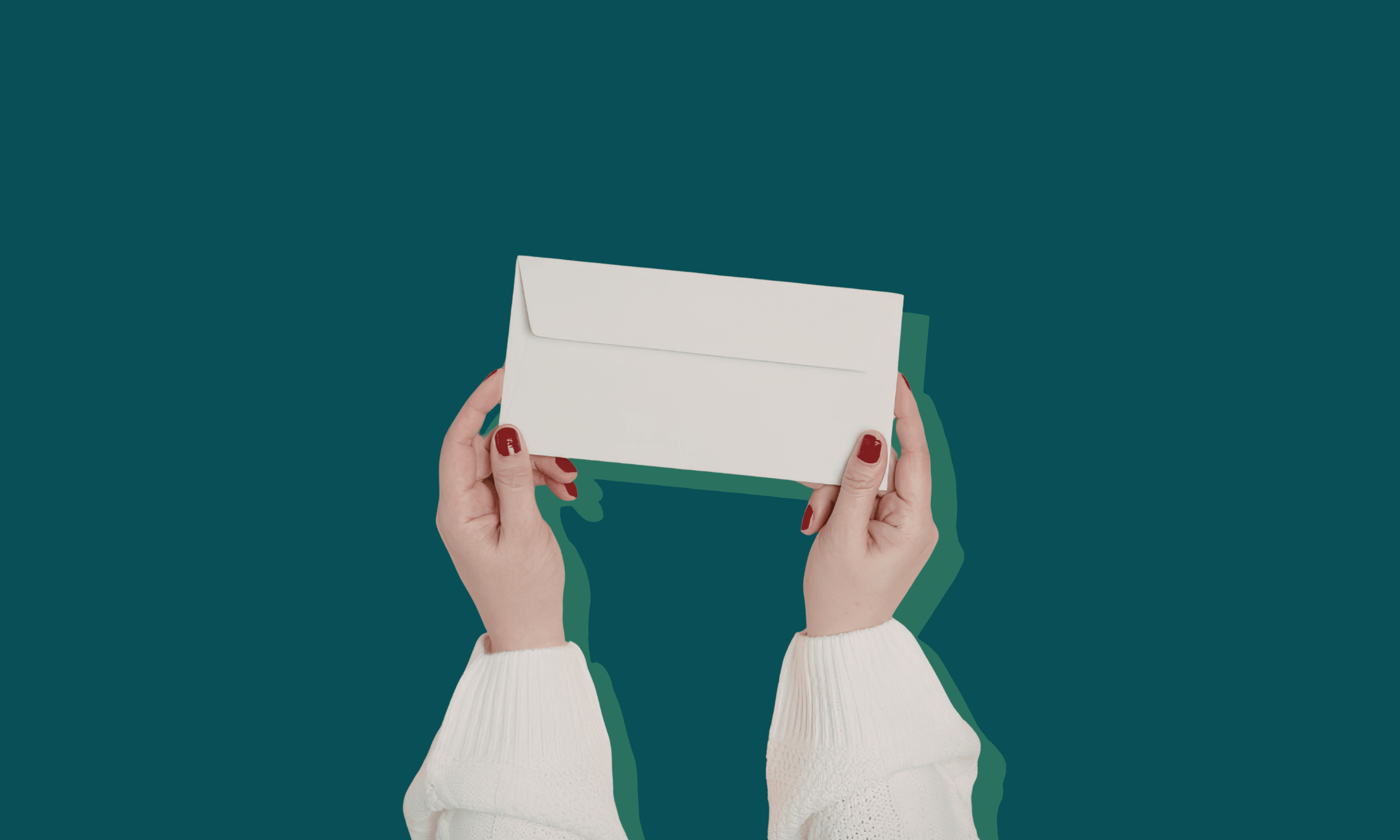 Two hands holding a blank white envelope against a dark teal background
